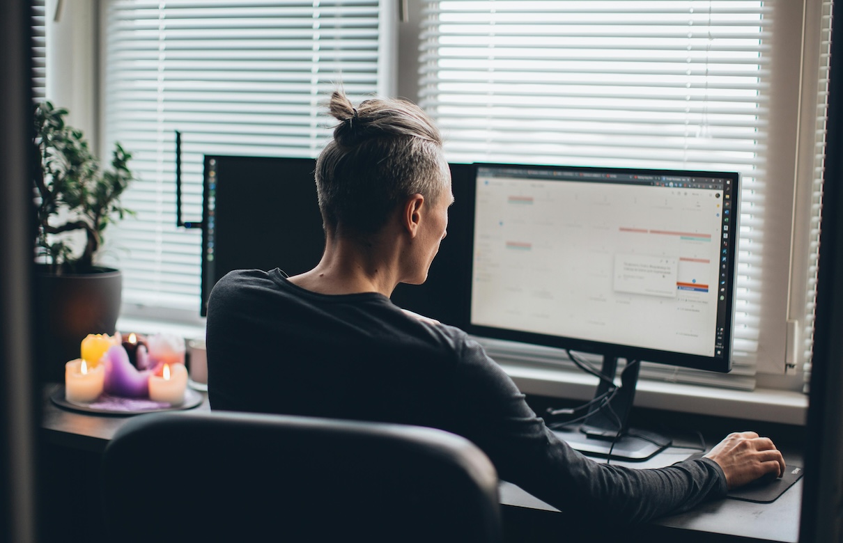 man working remotely on computer